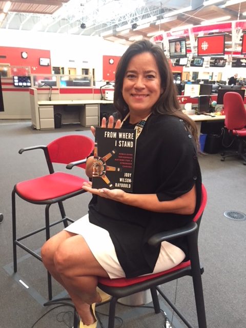 Jody Wilson-Raybould in a CBC office, holding a copy of her new book.